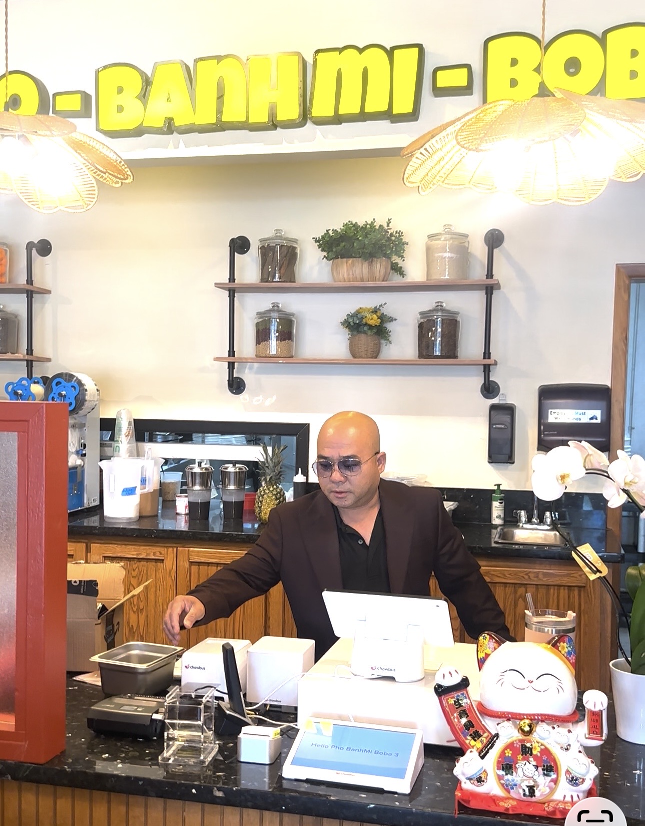 Restaurant owner using TL NextWave POS system at checkout counter